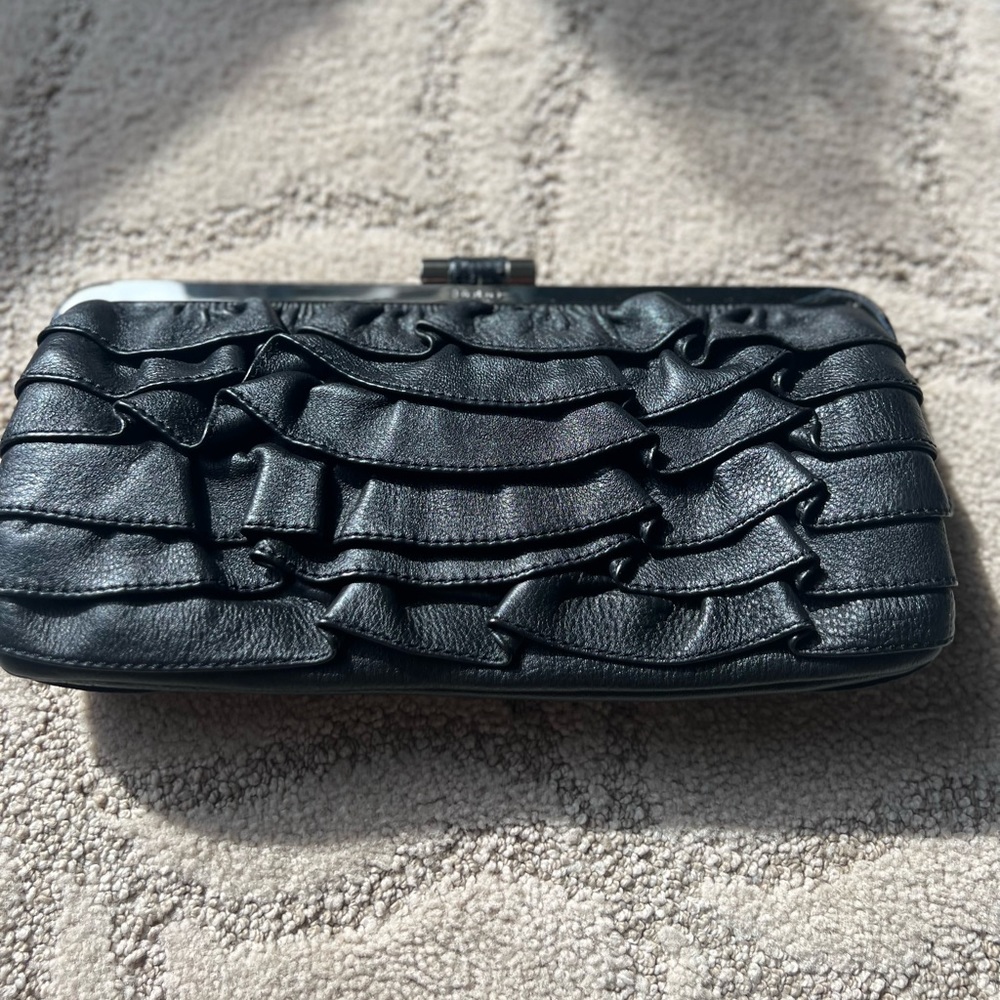 BEBE leather clutch